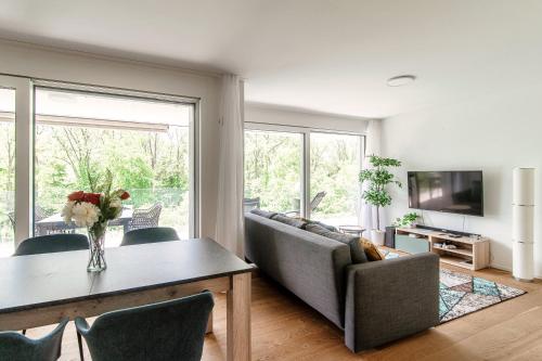 a living room with a couch and a table at Linda Terrace by Quokka 360 - modern one-bedroom flat with sun terrace in Locarno