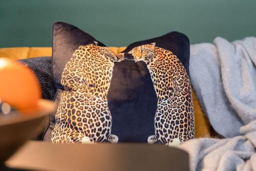 a cheetah print pillow on a couch at Stylish Cardiff City Apartment with Parking in Cardiff