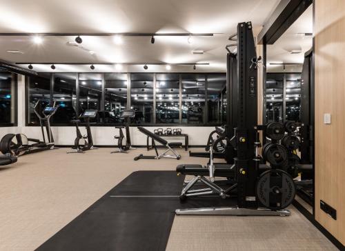 a gym with several treadmills and exercise machines at Arena Franz Ferdinand Nassfeld in Tröpolach