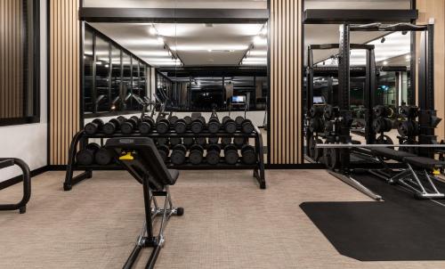 a gym with rows of equipment in a room at Arena Franz Ferdinand Nassfeld in Tröpolach
