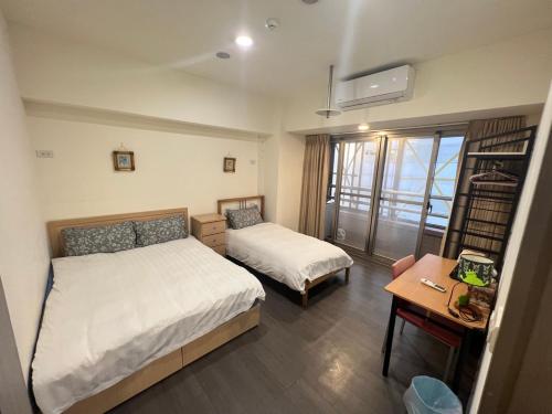 Ein Bett oder Betten in einem Zimmer der Unterkunft 果芒驛站旅店