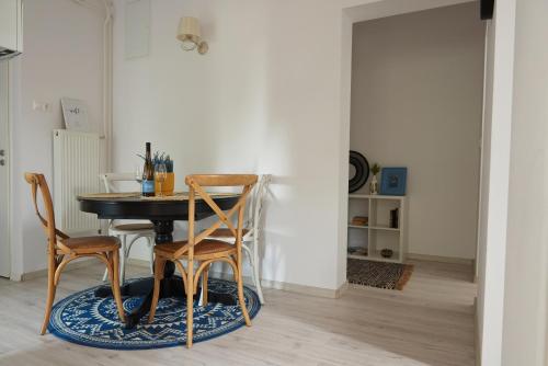 a dining room with a table and two chairs at Piccoleto Bianco in Badacsonytomaj