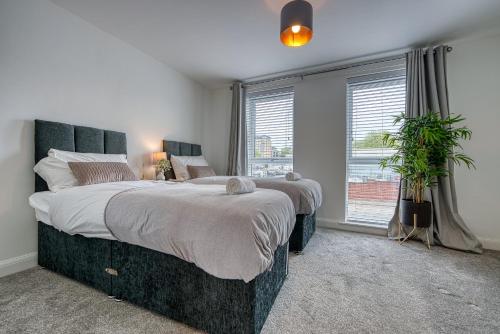 a bedroom with a large bed and a window at Spacious 4 BR House w/Parking in Birmingham