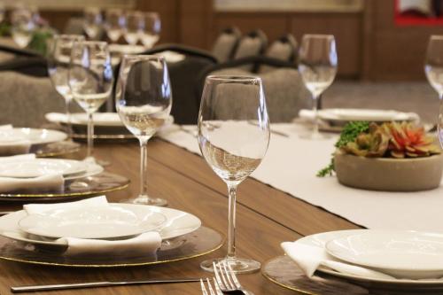 a table with wine glasses and plates on it at Culiacan Marriott Hotel in Culiacán