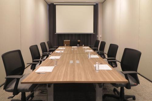 a conference room with a large wooden table and chairs at Culiacan Marriott Hotel in Culiacán