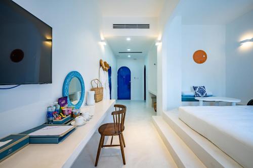 a bedroom with a bed and a desk with a chair at Happiness Hotel in Quy Nhon