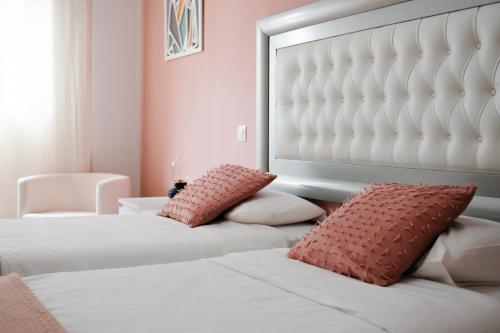 a bedroom with two beds and a large headboard at Resort Suites Vecindario in Vecindario