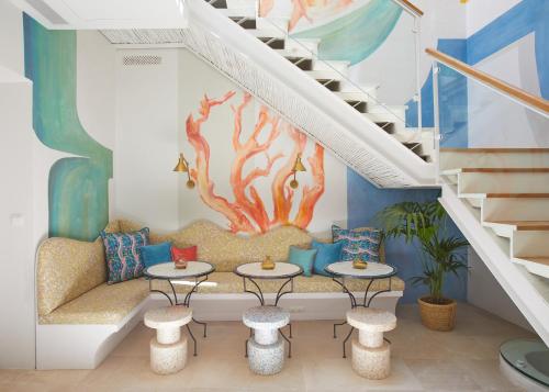 a living room with a couch and an underwater mural at El Escondite Tarifa in Tarifa