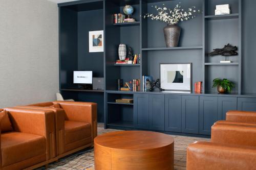 a waiting room with blue walls and orange chairs at Residence Inn by Marriott St Louis Clayton in Clayton