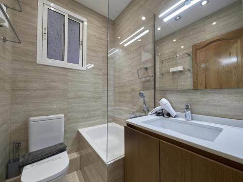 a bathroom with a sink and a toilet and a mirror at Avenida Gaudi Barcelona in Barcelona