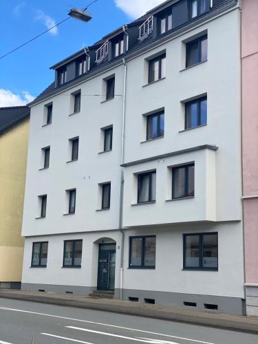 a white building on the side of a street at Wood-Appartement in Bielefeld