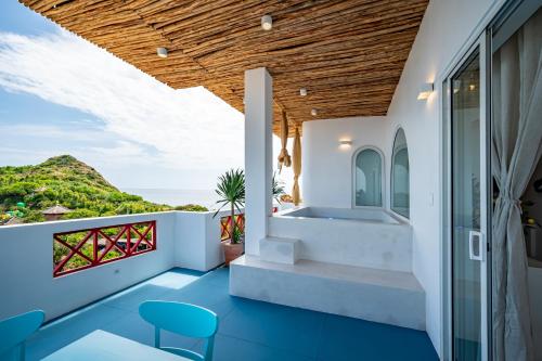 a balcony with blue flooring and a view of the ocean at Happiness Hotel in Quy Nhon