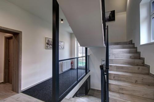 a staircase in a house with a glass railing at Vila Vyšehrad in Český Krumlov