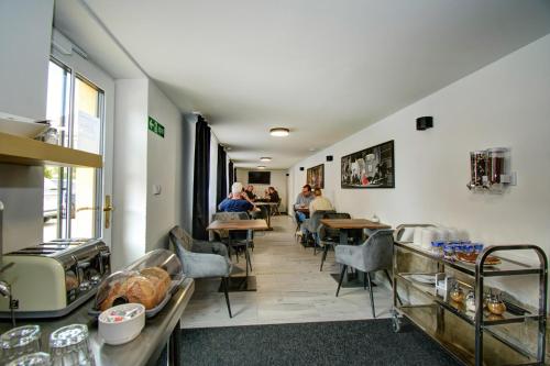 a restaurant with people sitting at tables in a room at Vila Vyšehrad in Český Krumlov