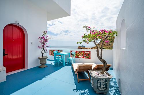a house with a red door and a bonsai tree on a balcony at Happiness Hotel in Quy Nhon
