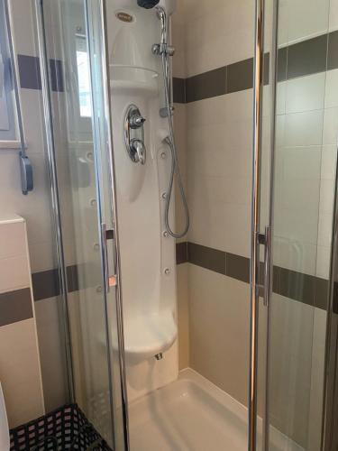 a bathroom with a shower with a glass door at Vila Pivac in Makarska