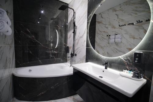 a bathroom with a sink and a mirror at HIDE PARK Hotel in Vinnytsya
