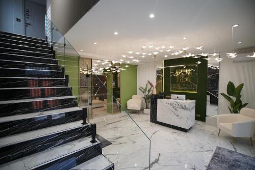 a lobby with a staircase in a building at HIDE PARK Hotel in Vinnytsya