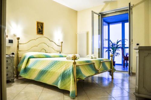 a bedroom with a large bed and a glass door at La casa al faro in Bari