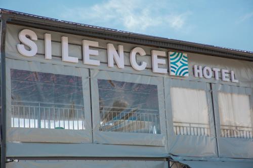 a sign for a cheese hotel on top of a building at Silence hotel in Cholpon-Ata