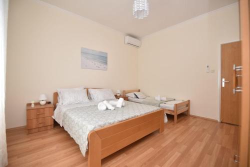 a bedroom with a bed with two white towels on it at Apartment Kap in Ivanica