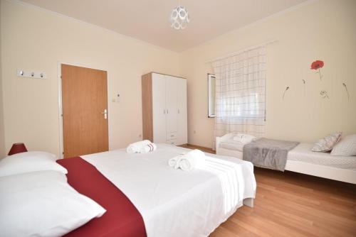 a bedroom with two beds with white sheets at Apartment Kap in Ivanica
