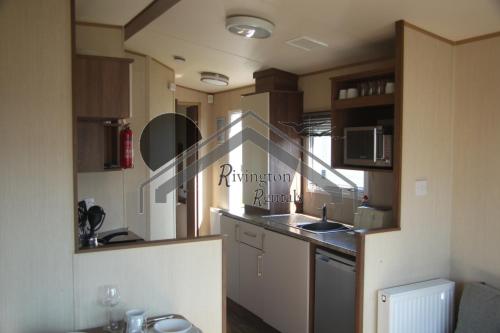 a kitchen with a sink and a counter top at The Rivington Lodge in Heysham