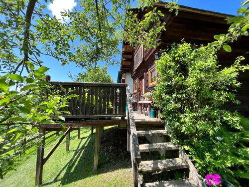 a wooden bench in front of a house at Chalet Reserl by Interhome in Lichtpold
