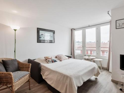 a bedroom with a bed and a chair at Apartment Résidence les Corsaires by Interhome in Saint-Jean-de-Luz