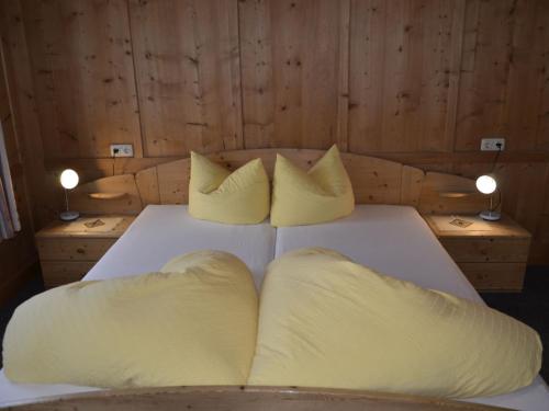 a bedroom with a bed with two pillows on it at Holiday Home Bergblick by Interhome in Kappl