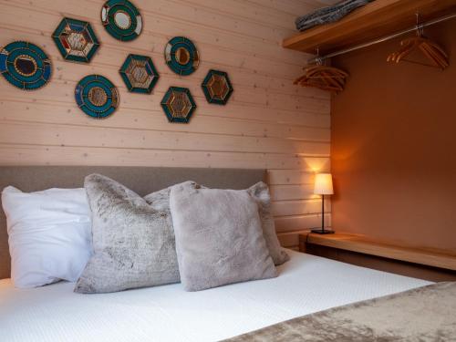 a bedroom with a bed with pillows and plates on the wall at Apartment Les Chouettes 23 by Interhome in Nendaz