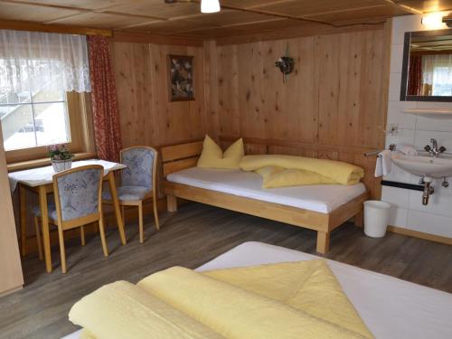 a bedroom with a bed and a sink and a table at Holiday Home Bergblick by Interhome in Kappl