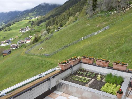 a balcony with pots of flowers and a hill at Holiday Home Bergblick by Interhome in Kappl