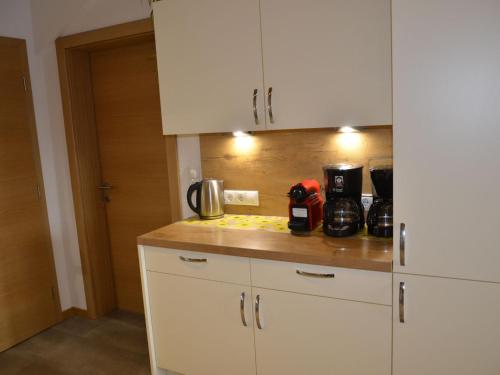 a kitchen with white cabinets and a counter top at Holiday Home Bergblick by Interhome in Kappl