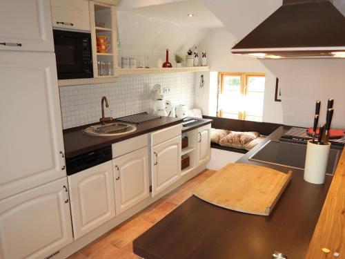 a kitchen with white cabinets and a counter top at Apartment Odin-2 by Interhome in Galmsbüll