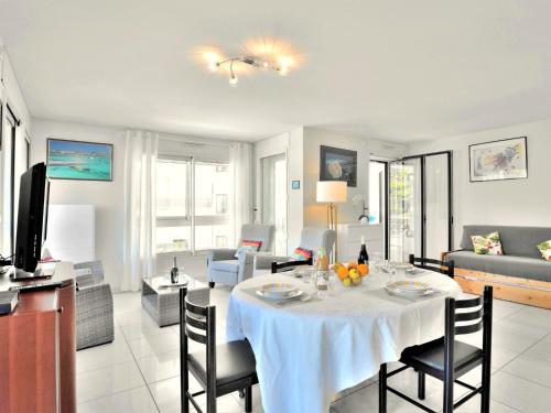 a living room with a table with chairs and a couch at Apartment Mariza by Interhome in La Baule