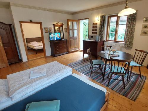 a bedroom with a bed and a dining room with a table at Apartment Alte Post-1 by Interhome in Aggsbach