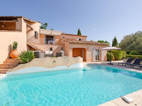 a large swimming pool in front of a house at Villa Le Petit Rouveau by Interhome in Guerre Vieille