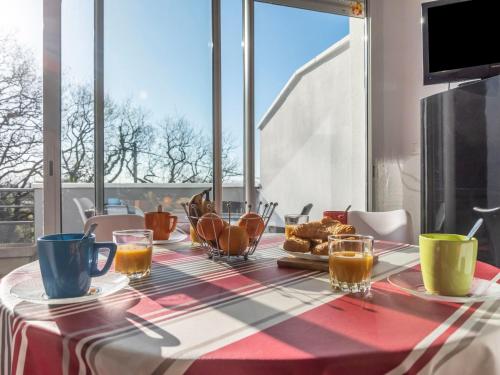 a table with coffee and croissants on top of it at Apartment Résidence Baigura-1 by Interhome in Saint-Jean-de-Luz