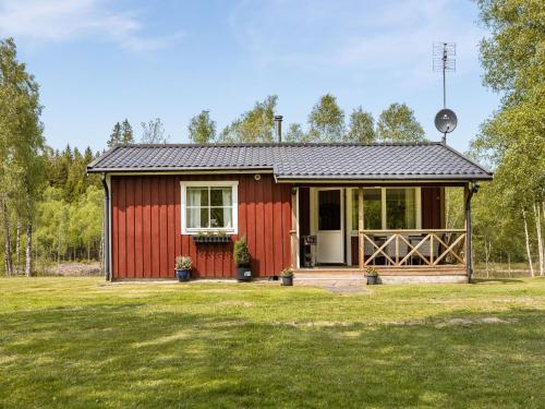 a small red house with a large yard at Chalet Björkebo by Interhome in Ätran