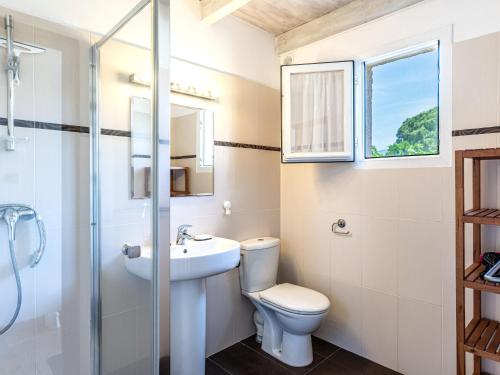 a bathroom with a toilet and a sink and a shower at Holiday Home La Pinède- bungalow 6 pers- by Interhome in Sagone