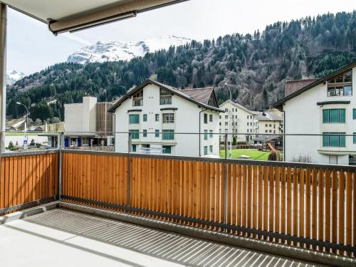 einen Balkon mit einem Holzzaun und Gebäuden in der Unterkunft Apartment TITLIS Resort 4-Zimmer Dachwohnung 5 in Engelberg