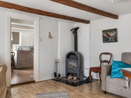 a living room with a wood stove in a room at Holiday Home Angsjö Torp by Interhome in Backaryd