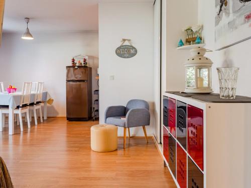 a living room with a chair and a table at Apartment Hortensia by Interhome in Cabourg