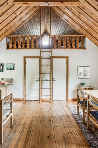an attic room with wooden floors and a ladder at Holiday Home Ängasjö by Interhome in Östra Frölunda