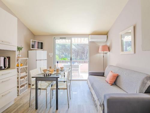 a living room with a couch and a table at Apartment Le Thalassa 1 by Interhome in Sainte-Maxime