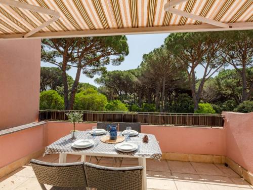 a patio with a table and chairs on a balcony at Apartment Le Thalassa 1 by Interhome in Sainte-Maxime