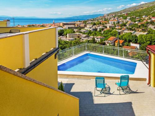 a pool on the balcony of a house with two chairs at Apartment Miškulin-1 by Interhome in Senj
