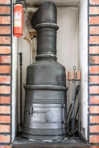 a large black stove in the corner of a building at Chalet Löaborn by Interhome in Kopparberg