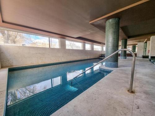 a large swimming pool in a building with a pool at Fozpalace Sweet Home in Portimão